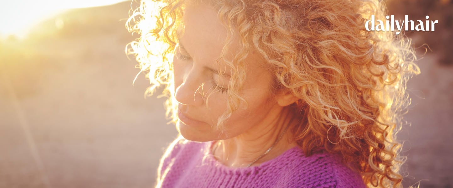 A woman with blonde hair and closed eyes